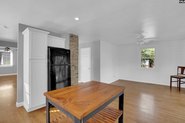 dining space with ceiling fan, a healthy amount of sunlight, and light hardwood / wood-style flooring