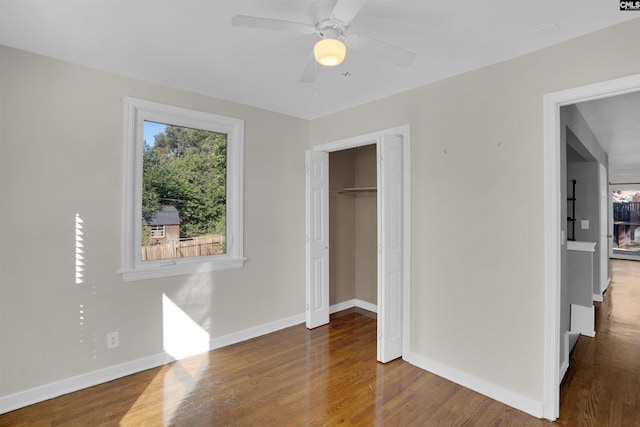 bedroom with a closet, dark hardwood / wood-style floors, and ceiling fan