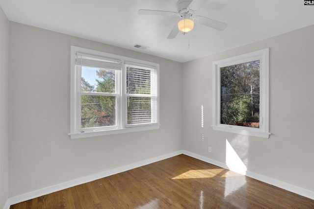 empty room with hardwood / wood-style flooring and ceiling fan