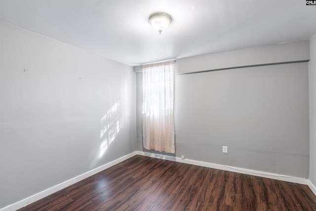 spare room with dark hardwood / wood-style floors