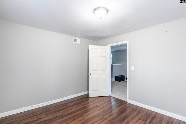 empty room featuring dark hardwood / wood-style flooring