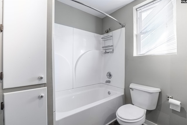 bathroom featuring shower / bath combination and toilet