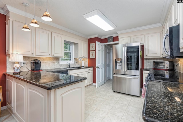 kitchen featuring kitchen peninsula, hanging light fixtures, stainless steel appliances, and ornamental molding