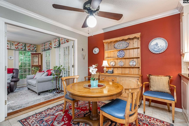 dining room featuring light tile patterned floors and crown molding