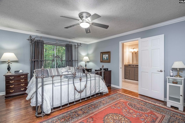 bedroom with a textured ceiling, ensuite bath, ceiling fan, and ornamental molding