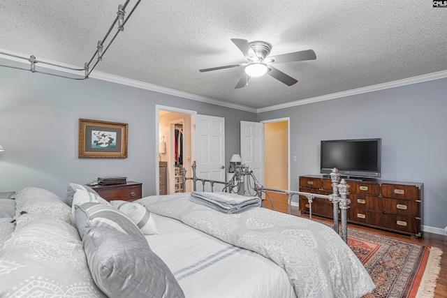 bedroom with a textured ceiling, ceiling fan, crown molding, and hardwood / wood-style flooring