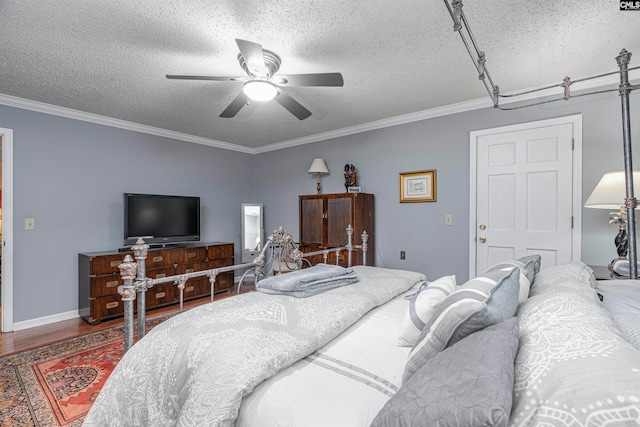 bedroom featuring ceiling fan, hardwood / wood-style flooring, a textured ceiling, and ornamental molding