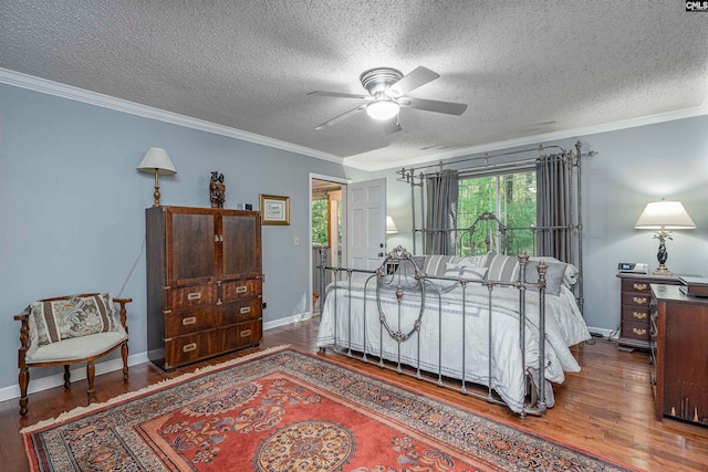 bedroom featuring wood-type flooring, a textured ceiling, ceiling fan, and ornamental molding