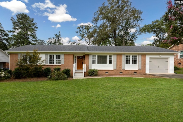 ranch-style house featuring a garage and a front lawn