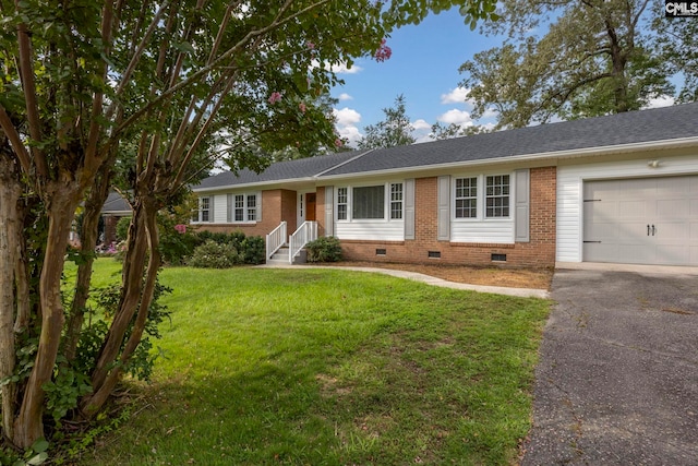 ranch-style house featuring a front lawn and a garage