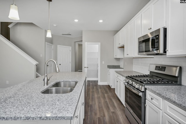 kitchen featuring sink, stainless steel appliances, dark hardwood / wood-style flooring, an island with sink, and white cabinets