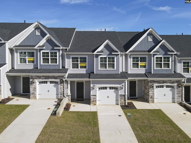 view of front of property featuring a garage and a front lawn