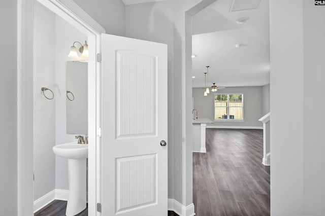 bathroom featuring hardwood / wood-style floors, ceiling fan, and sink