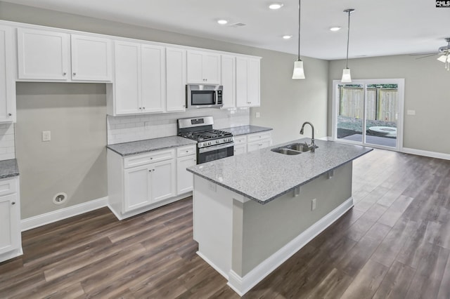 kitchen featuring light stone counters, sink, white cabinets, and stainless steel appliances