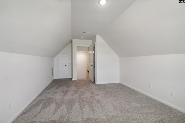 additional living space featuring light carpet and lofted ceiling