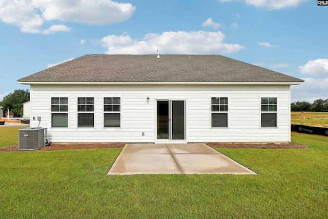 rear view of property featuring central AC, a yard, and a patio