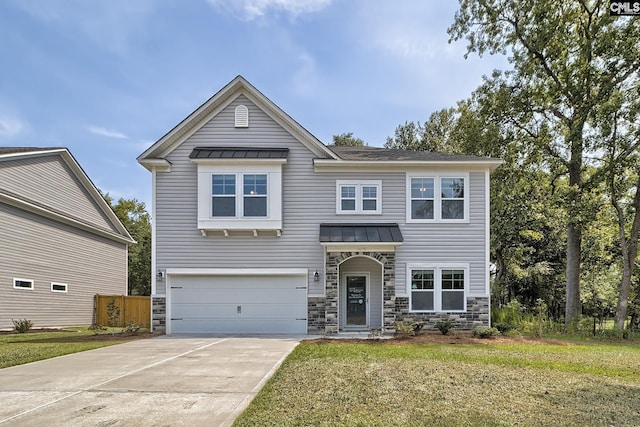 view of front of house featuring a garage and a front yard