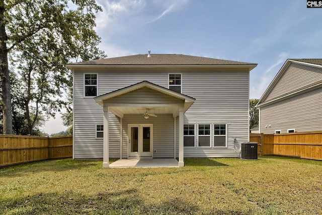 rear view of house with ceiling fan, a yard, a patio, and central AC unit