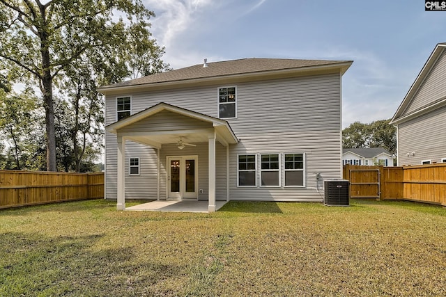 back of house with central air condition unit, ceiling fan, a lawn, and a patio