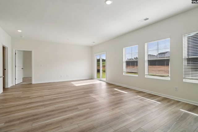 unfurnished room with light wood-type flooring