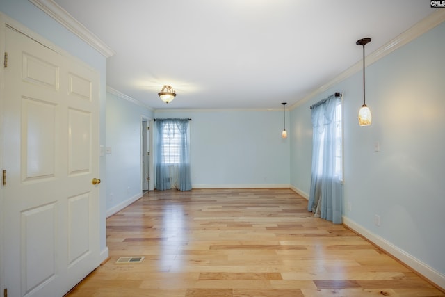 spare room with light hardwood / wood-style flooring and ornamental molding