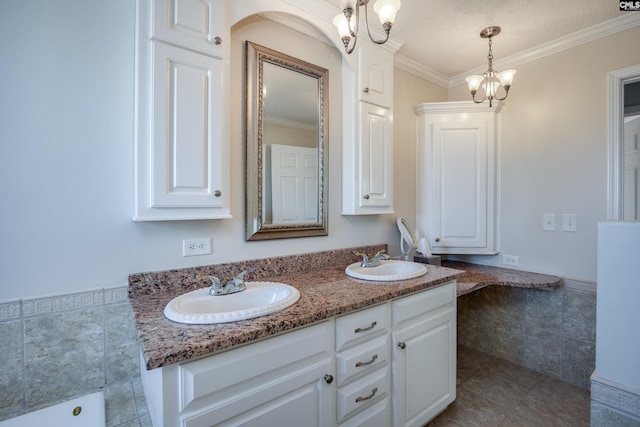 bathroom featuring a textured ceiling, vanity, crown molding, and tile patterned floors