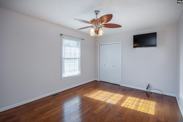 spare room with hardwood / wood-style floors and ceiling fan