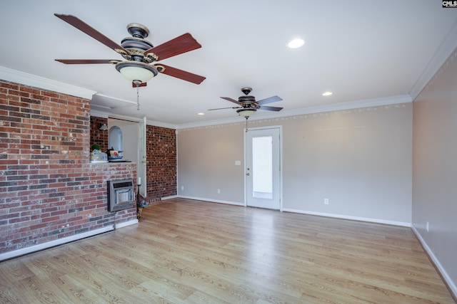 unfurnished living room with crown molding, ceiling fan, brick wall, and light wood-type flooring