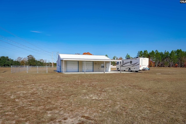 back of house with a lawn, covered porch, and a carport