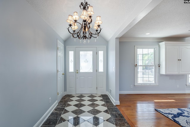 foyer featuring a chandelier, a textured ceiling, lofted ceiling with beams, and dark hardwood / wood-style floors