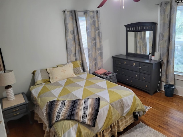 bedroom featuring hardwood / wood-style flooring, multiple windows, and ceiling fan