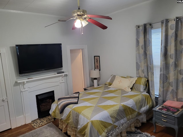 bedroom with hardwood / wood-style floors, ceiling fan, and crown molding