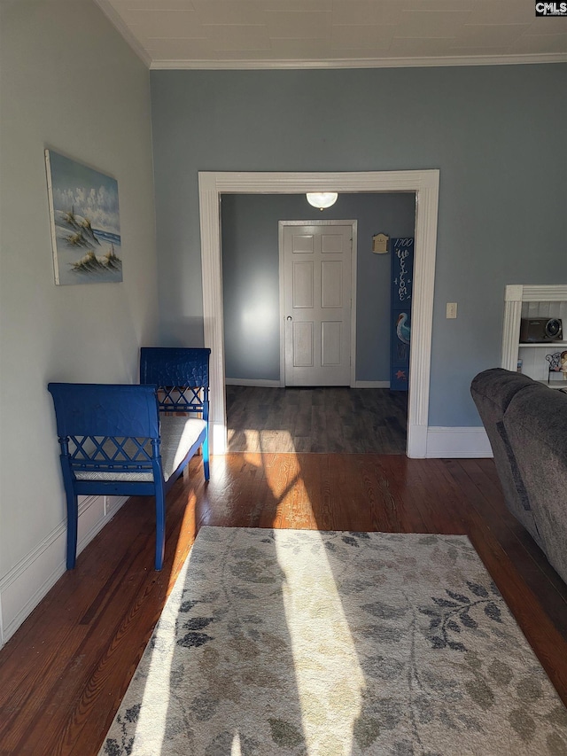 entryway with dark wood-type flooring and ornamental molding