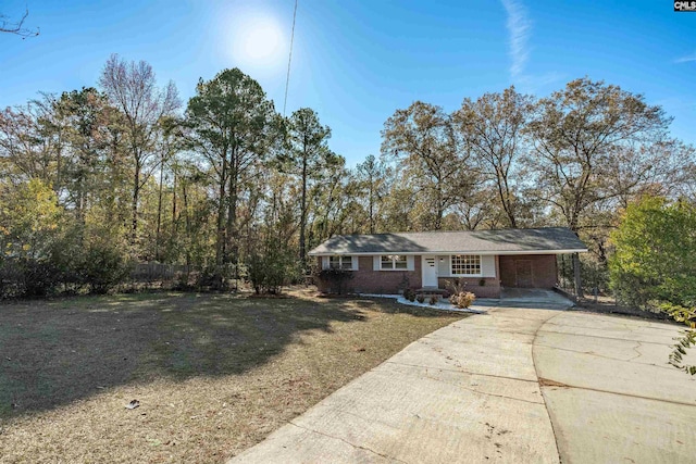 ranch-style house featuring a front yard and a carport