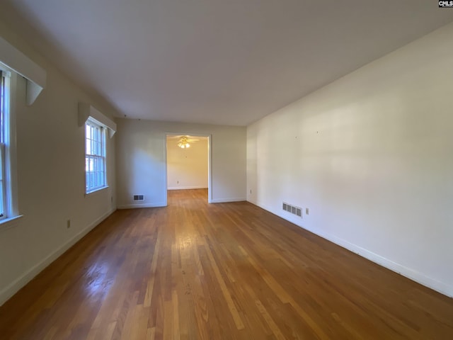 empty room featuring hardwood / wood-style floors and ceiling fan