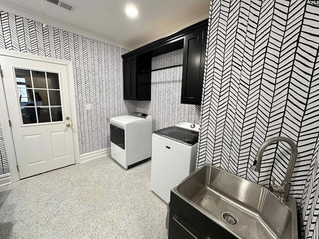 laundry area featuring cabinets, sink, washer / dryer, and crown molding