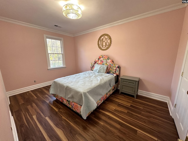 bedroom with dark hardwood / wood-style flooring and ornamental molding