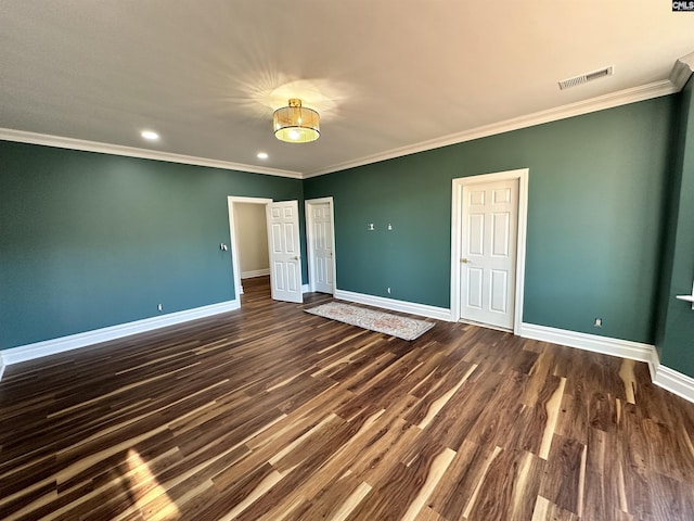 unfurnished bedroom featuring ornamental molding and dark wood-type flooring