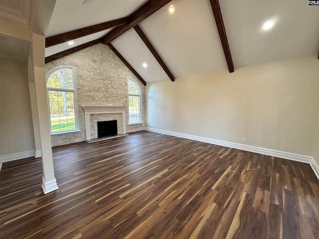 unfurnished living room with a fireplace, beamed ceiling, dark hardwood / wood-style floors, and high vaulted ceiling