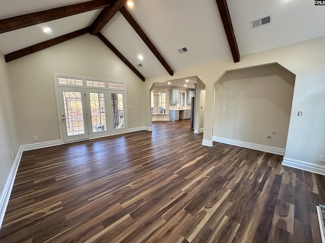 unfurnished living room featuring beam ceiling, dark hardwood / wood-style flooring, and high vaulted ceiling