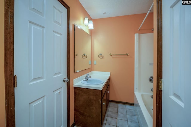 bathroom featuring bathing tub / shower combination, tile patterned flooring, vanity, and a textured ceiling