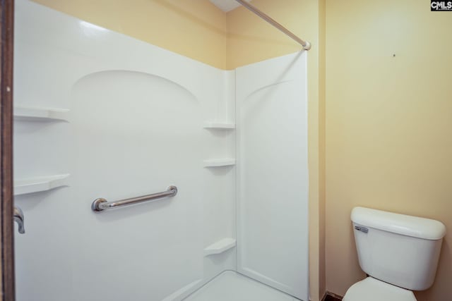 bathroom with toilet and a shower