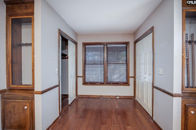 hall with dark wood-type flooring