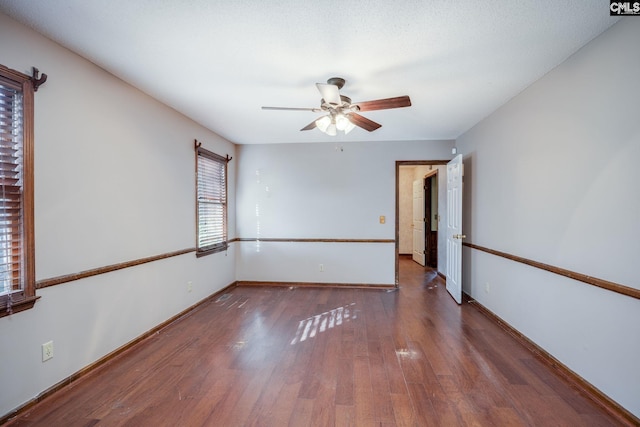 unfurnished room featuring ceiling fan and dark hardwood / wood-style flooring