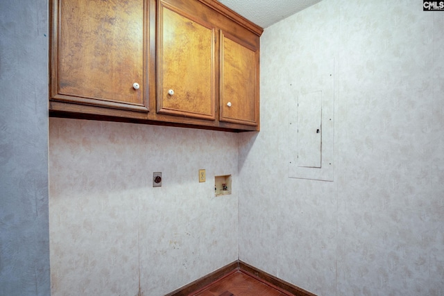 laundry room with hookup for an electric dryer, hookup for a washing machine, cabinets, a textured ceiling, and electric panel