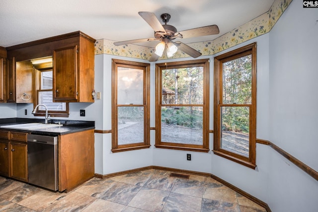 kitchen featuring a textured ceiling, dishwasher, ceiling fan, and sink