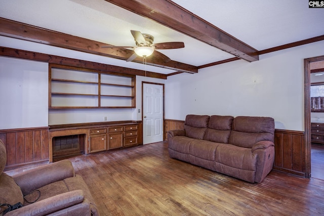 living room with beamed ceiling, wooden walls, ceiling fan, and dark wood-type flooring