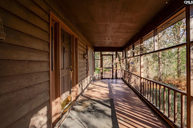 unfurnished sunroom with wood ceiling