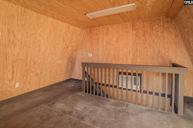 spare room featuring wood walls, wood ceiling, and vaulted ceiling