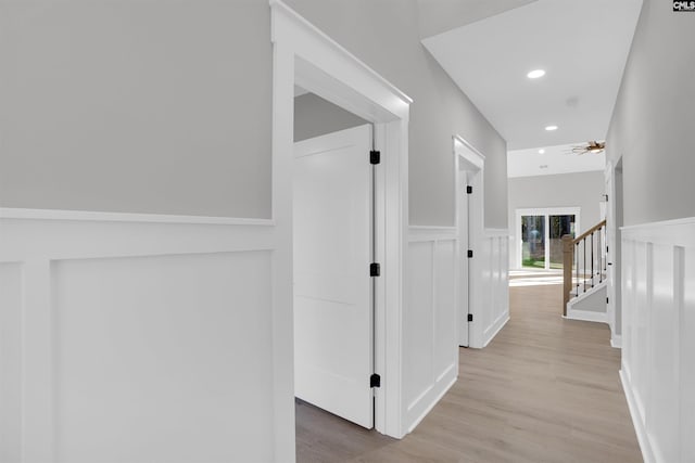 hallway with light hardwood / wood-style floors
